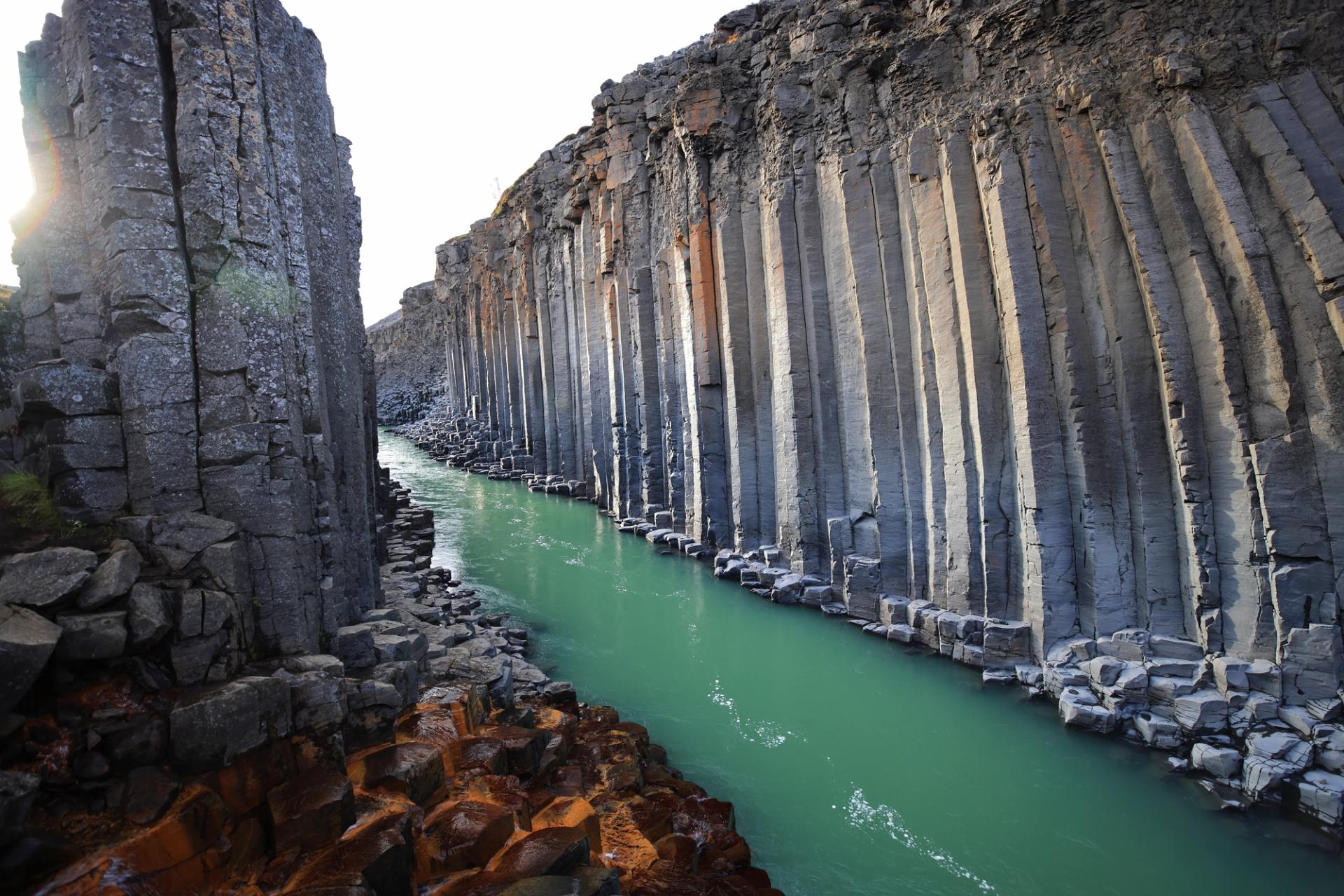 The azure waters and basalt columns of Stuðlagil Canyon.