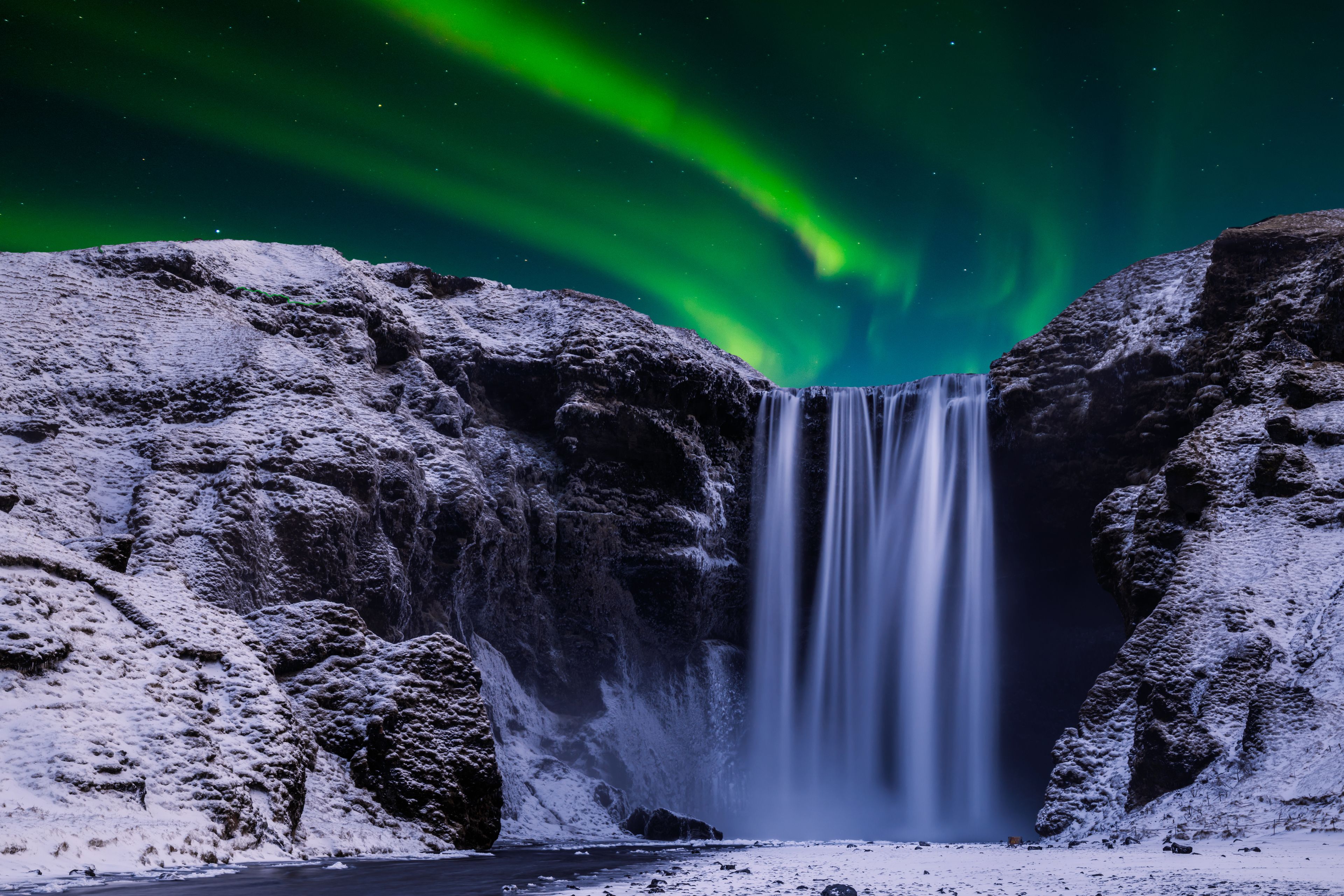 Skógafoss waterfall under the Northern Lights