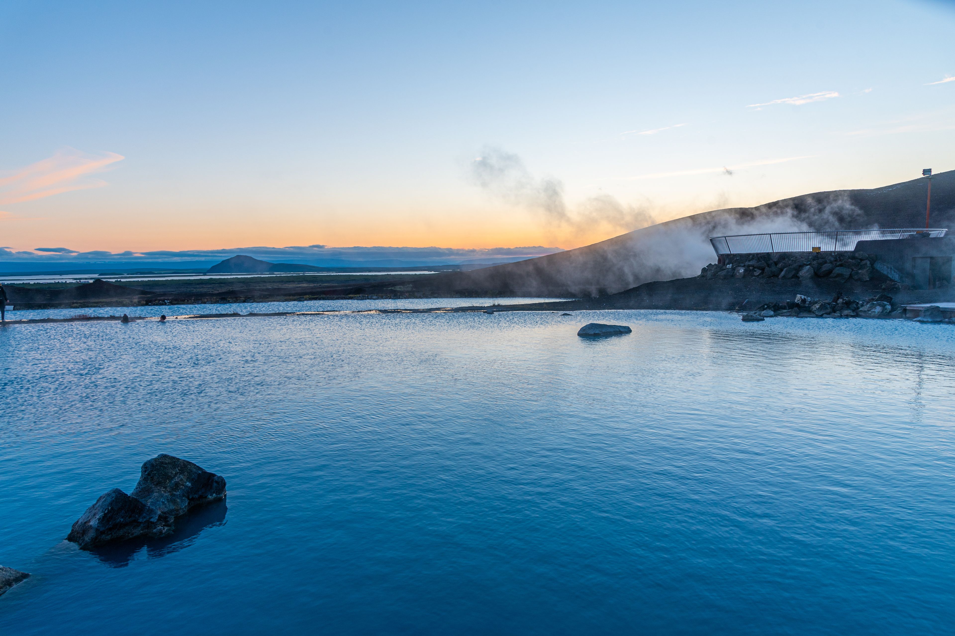 view on the baths of Myvatn, we see the baths, the sunset and the landscapes of Iceland in the distance 