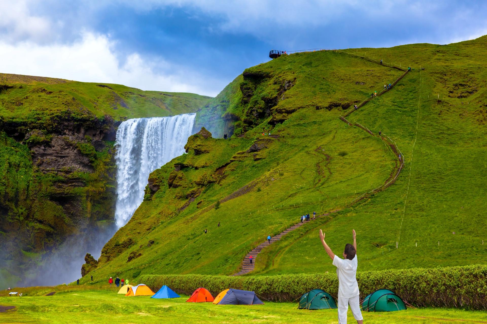 Near a waterfall in Iceland a tourist tents