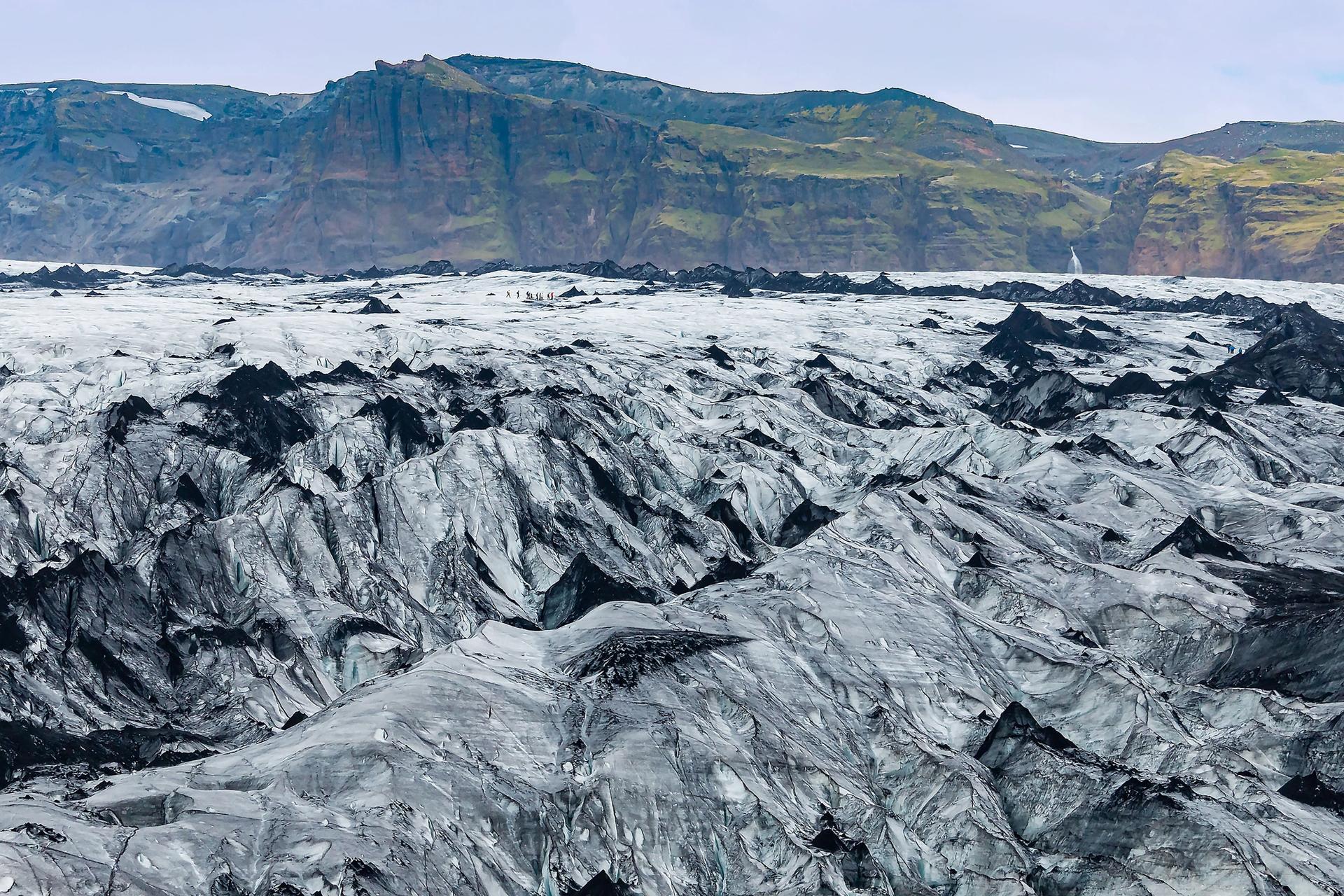 View of people hike tour through Myrdalsjokull Glacier in Iceland 
