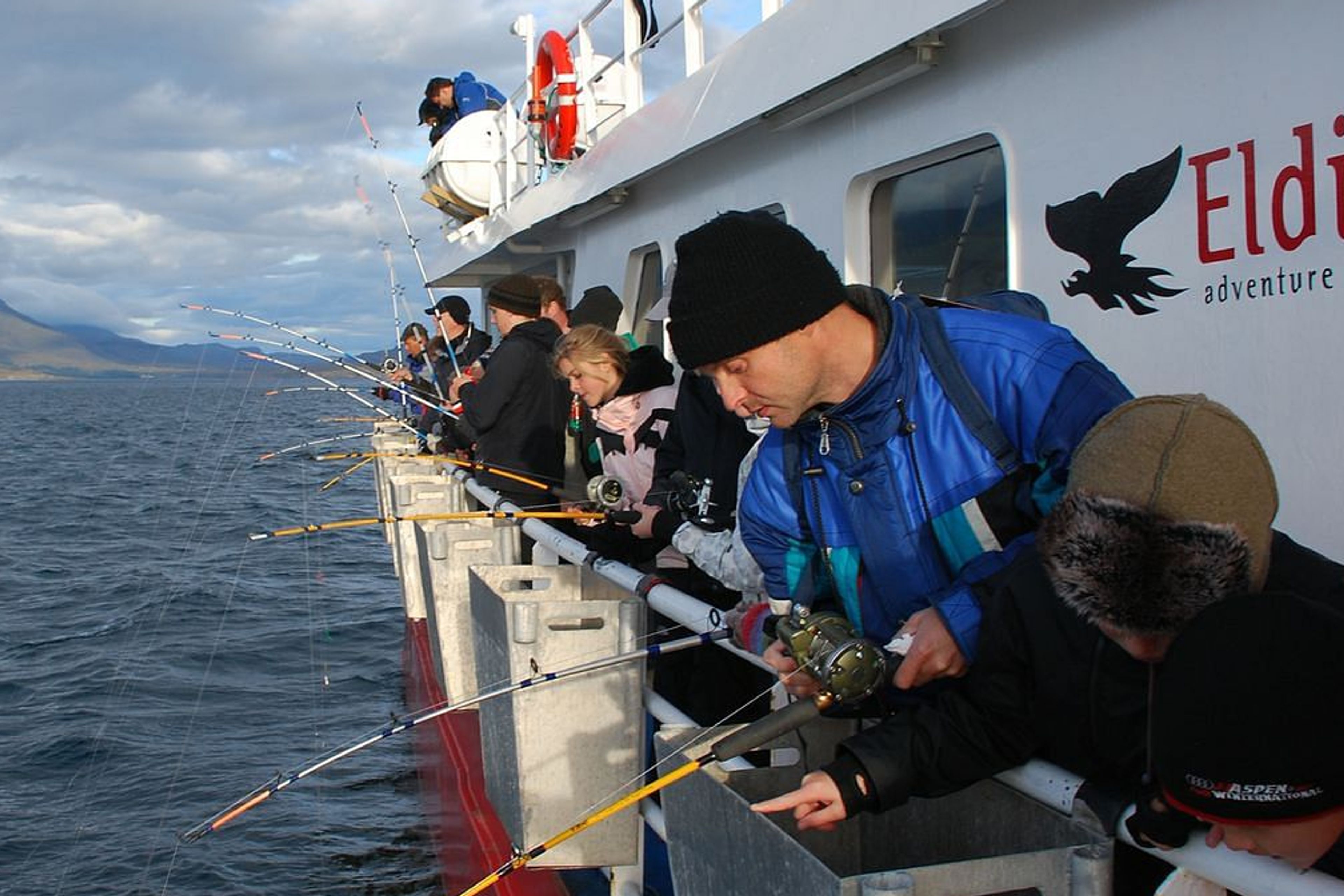 a group of people went out to sea to fish, excursion in Iceland 