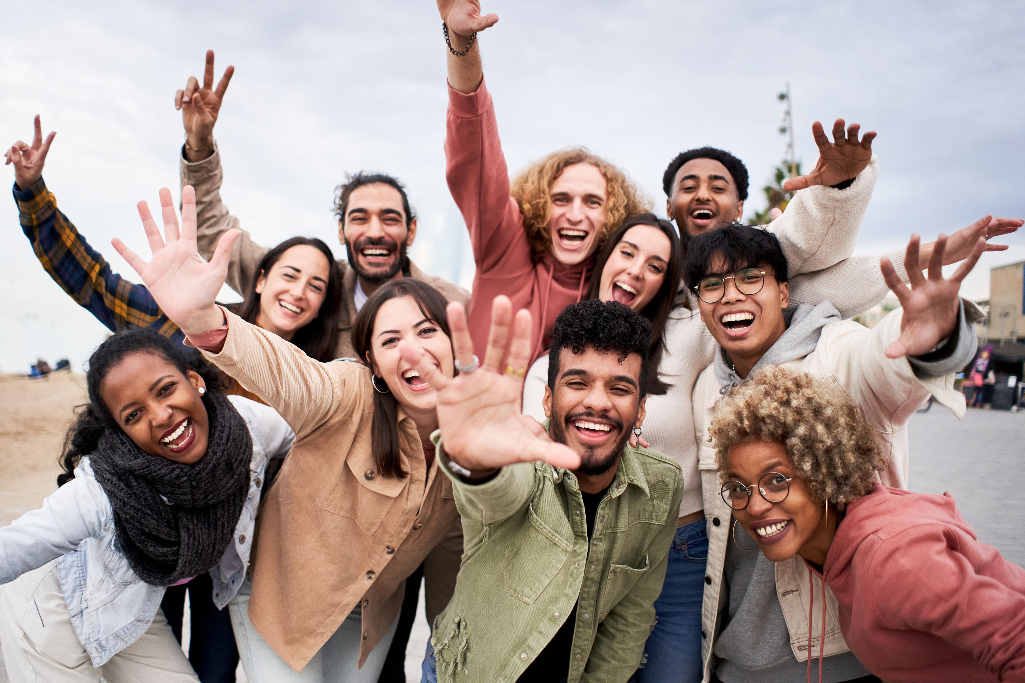 Big group of cheerful people, looking at the camera smiling and taking a selfie