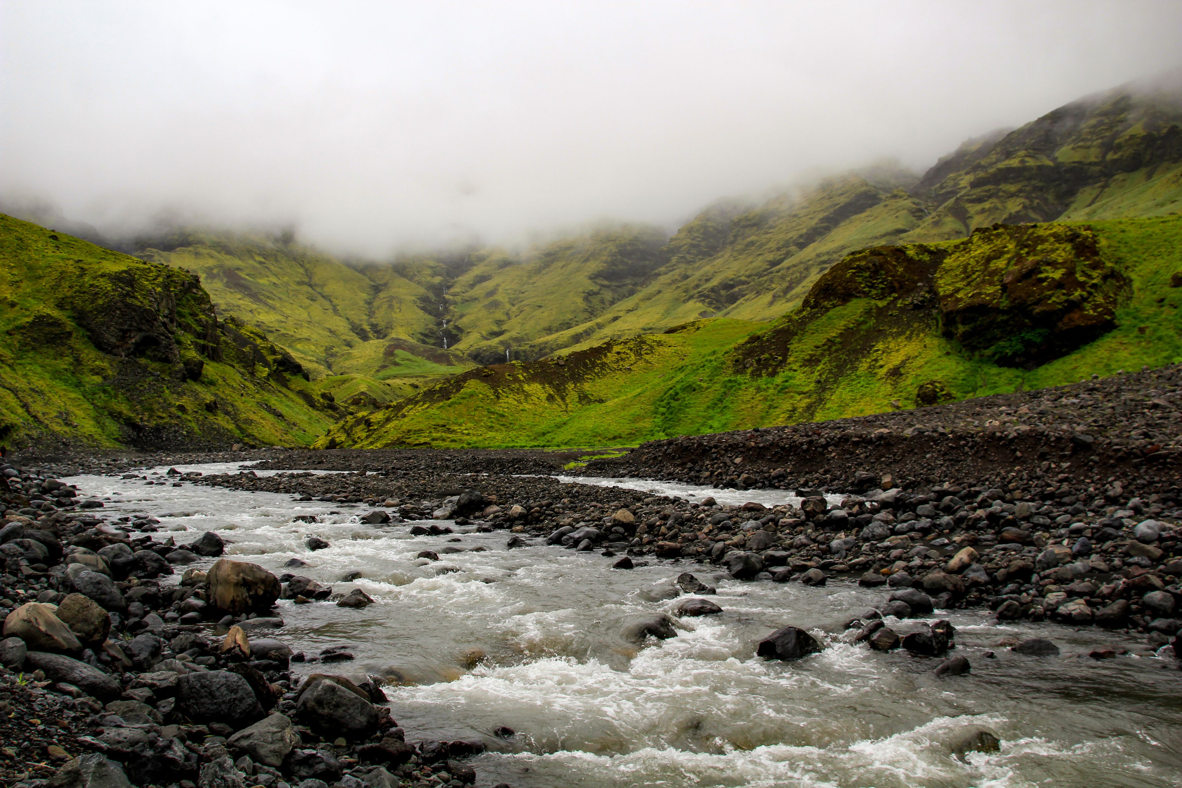 Iceland's Seljavellir valley contains lava rocks that have been covered in moss and a river.