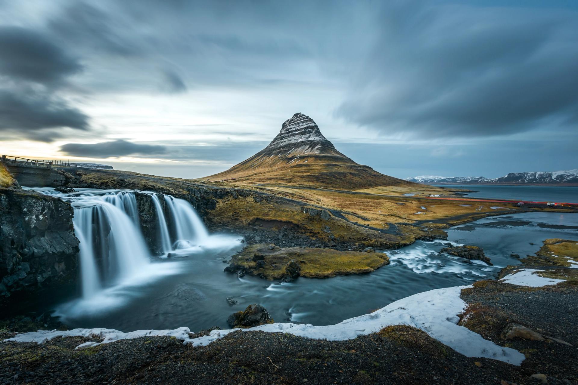 Kirkjufell mountain with its unique shape and Kirkjufellsfoss waterfall in the foreground