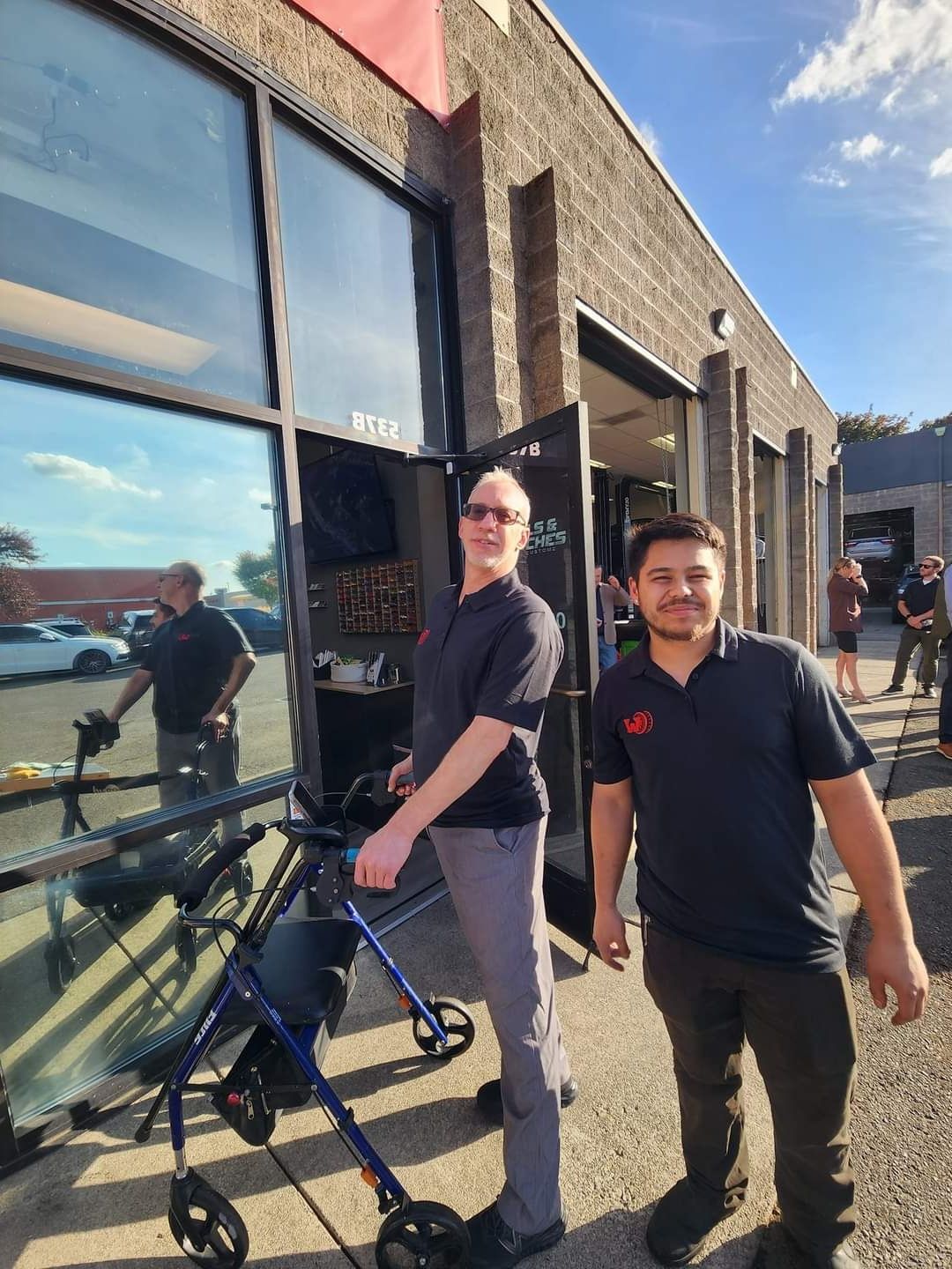 Co-founders Joel Staab and CJ Bicknell standing outside the front door of Wheels & Wrenches.