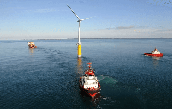 Three vessels transporting a floating wind turbine
