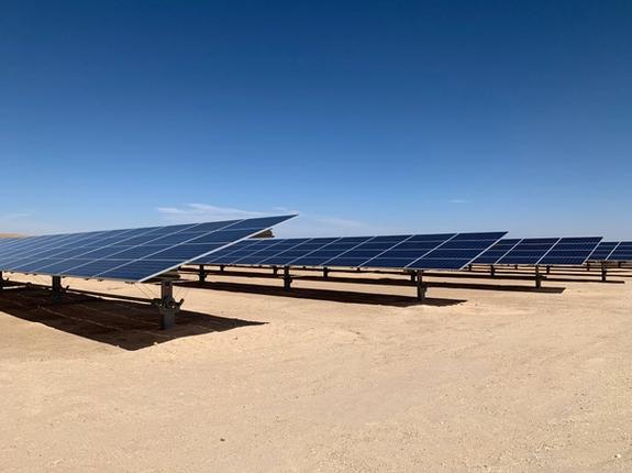 Photo of a solar panels in a desert