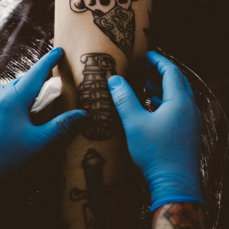 Traditional tattoo being applied in studio showing bold outlines and classic flash-style design
