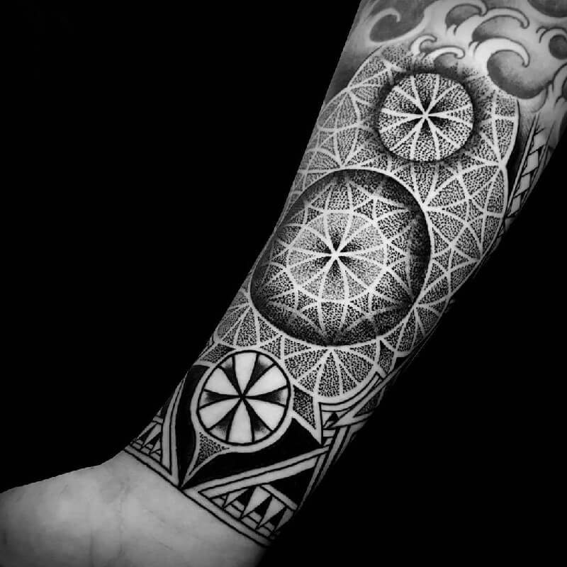 Dotwork mandala tattoo with geometric patterns and gradient stippling on forearm