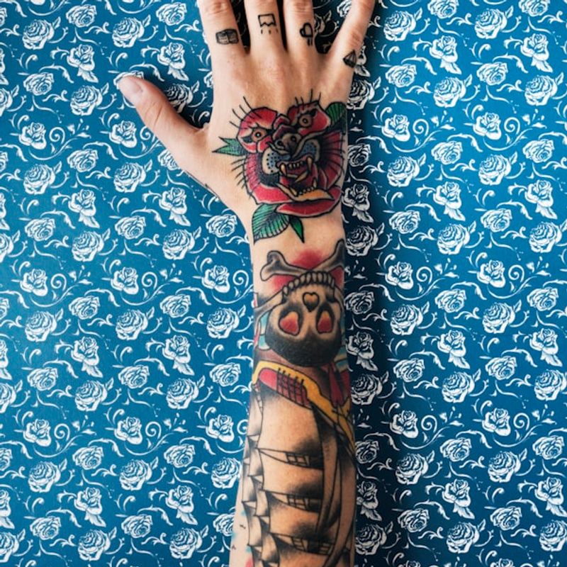 Watercolor floral tattoo with soft color blending on upper arm