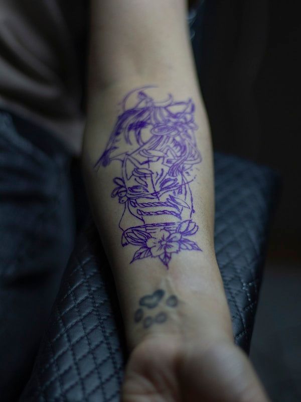 Photorealistic portrait tattoo with fine detail work on upper arm