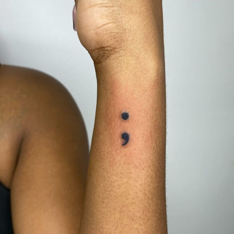 Classic semicolon tattoo on inner wrist — the most iconic placement for mental health awareness