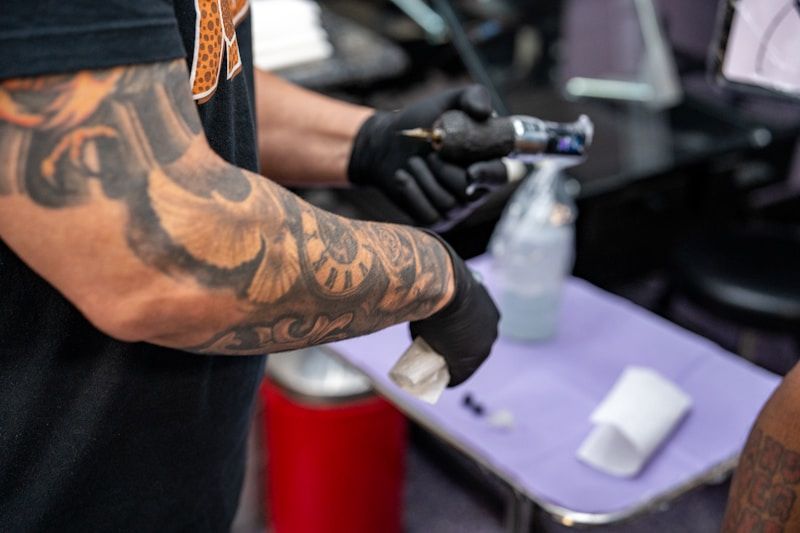Tattoo artist preparing sterile equipment in a clean studio