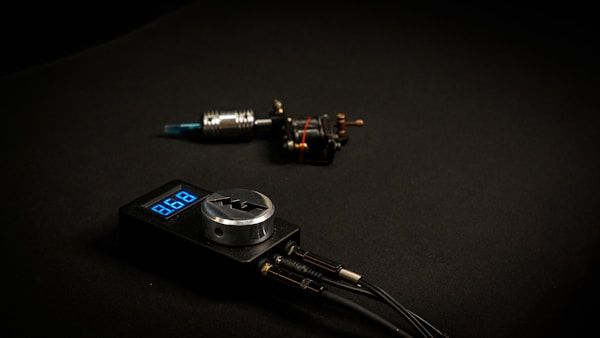 Modern tattoo machine and power supply setup for precision digital tattooing