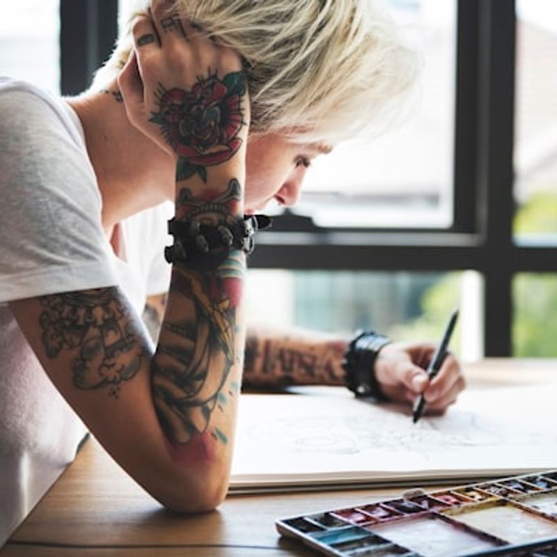 Creative watercolor tattoo design with paint splash effects