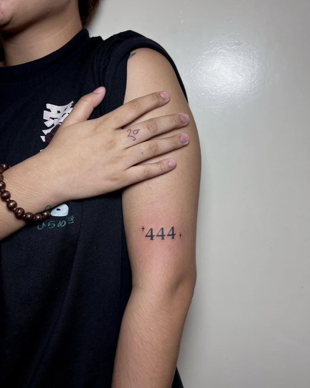 Spiritual 444 tattoo design with decorative elements on forearm