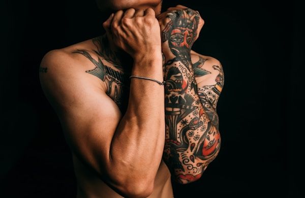 Full sleeve Japanese tattoo with bold black outlines and bokashi shading