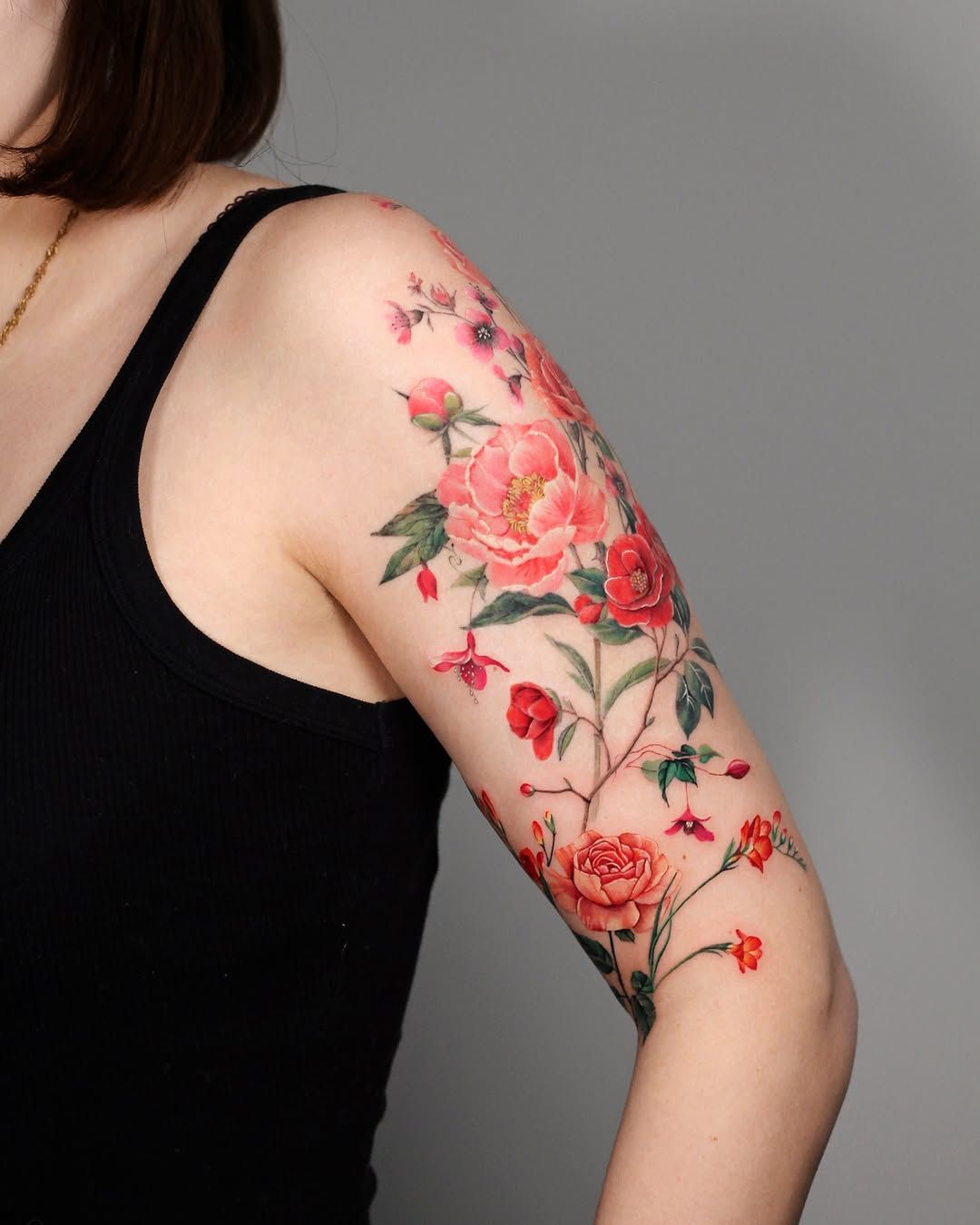 Fully healed vibrant colourful flower tattoo on arm showing results of proper aftercare