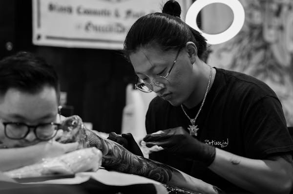 Tattoo session in progress at a professional studio — typical session costs depend on duration and artist experience