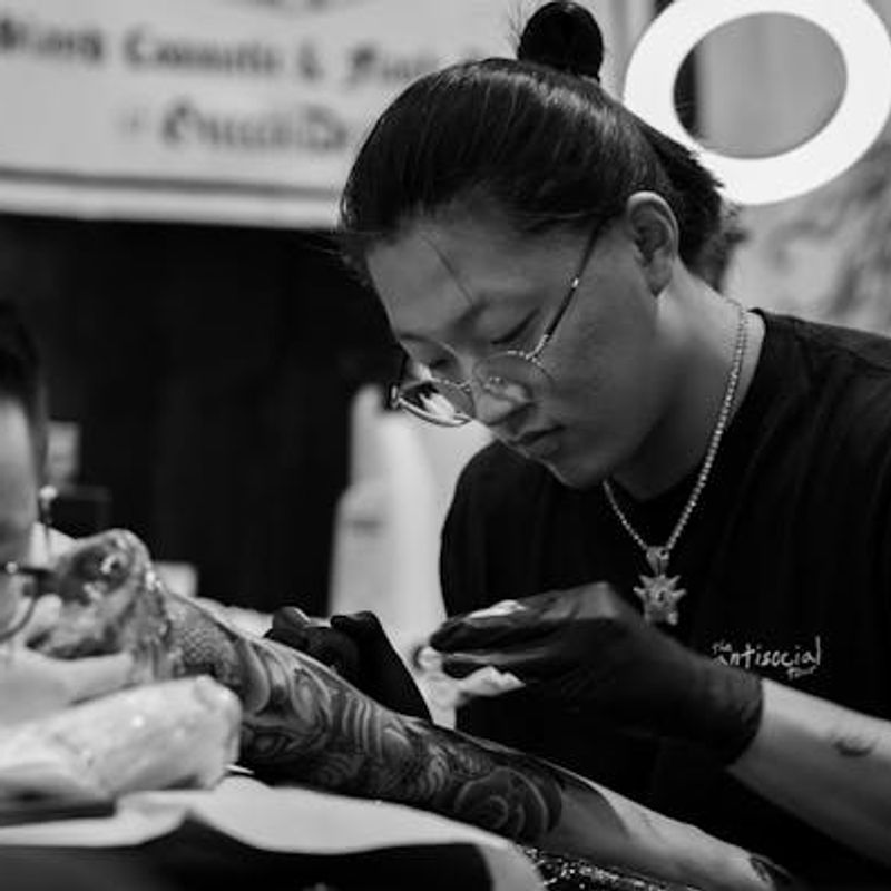 Tattoo session in progress at a professional studio — typical session costs depend on duration and artist experience