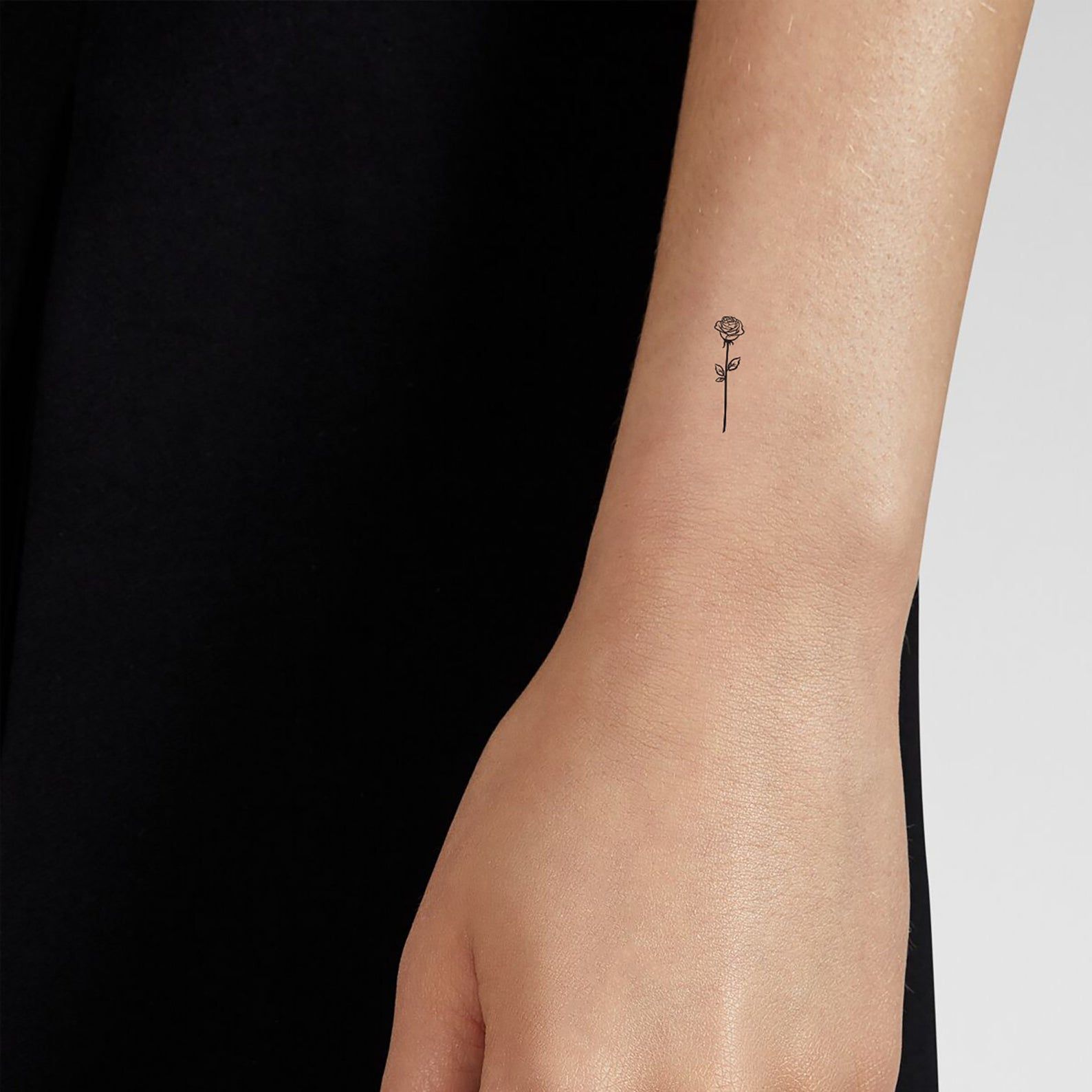 Tiny micro tattoo with intricate single-needle detail on forearm