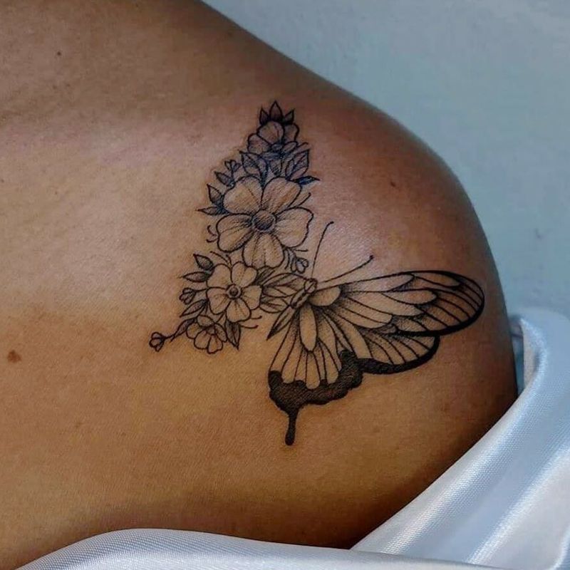 Detailed butterfly tattoo with realistic wing shading on skin