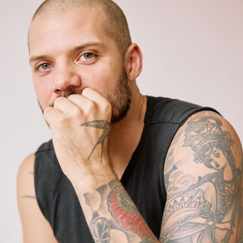 Japanese Irezumi sleeve tattoo with traditional koi and wave motifs on upper arm