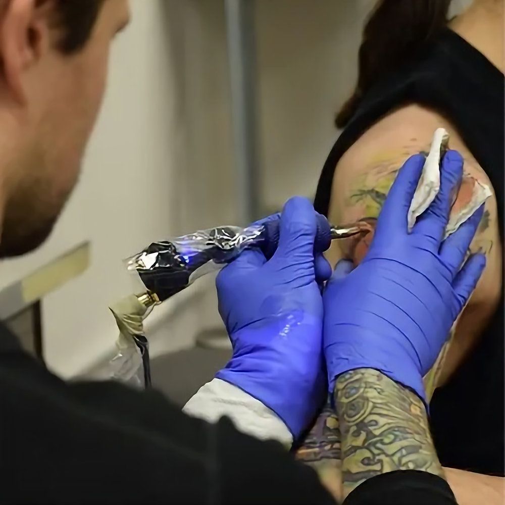 Client and tattoo artist discussing payment after a tattoo session