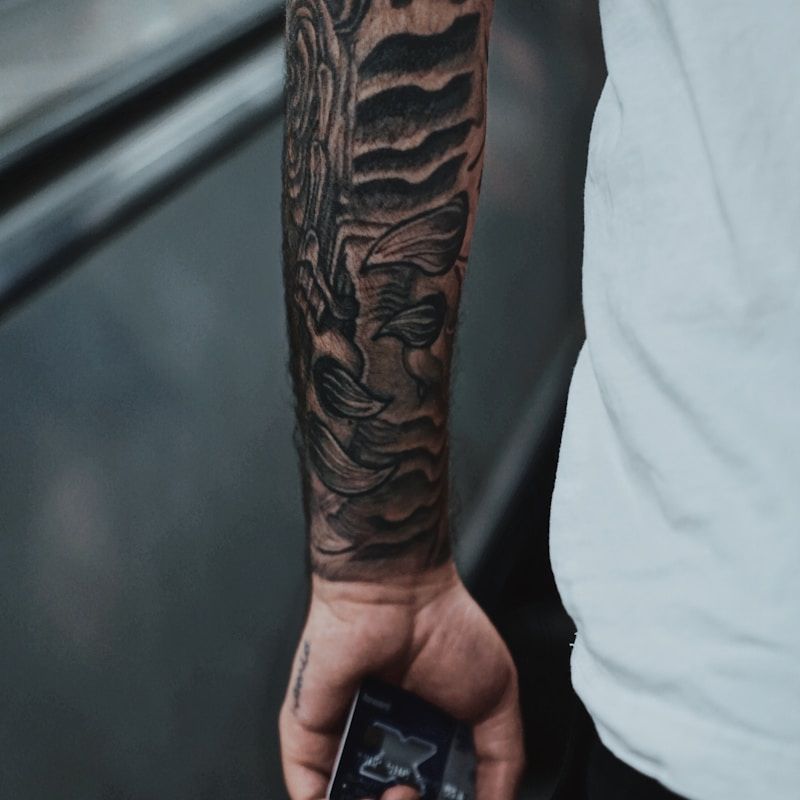 Blackwork sleeve tattoo with abstract organic patterns on forearm