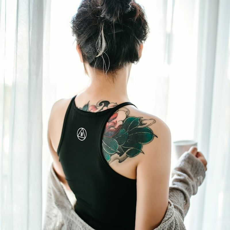 Japanese floral back piece tattoo with peony and chrysanthemum design