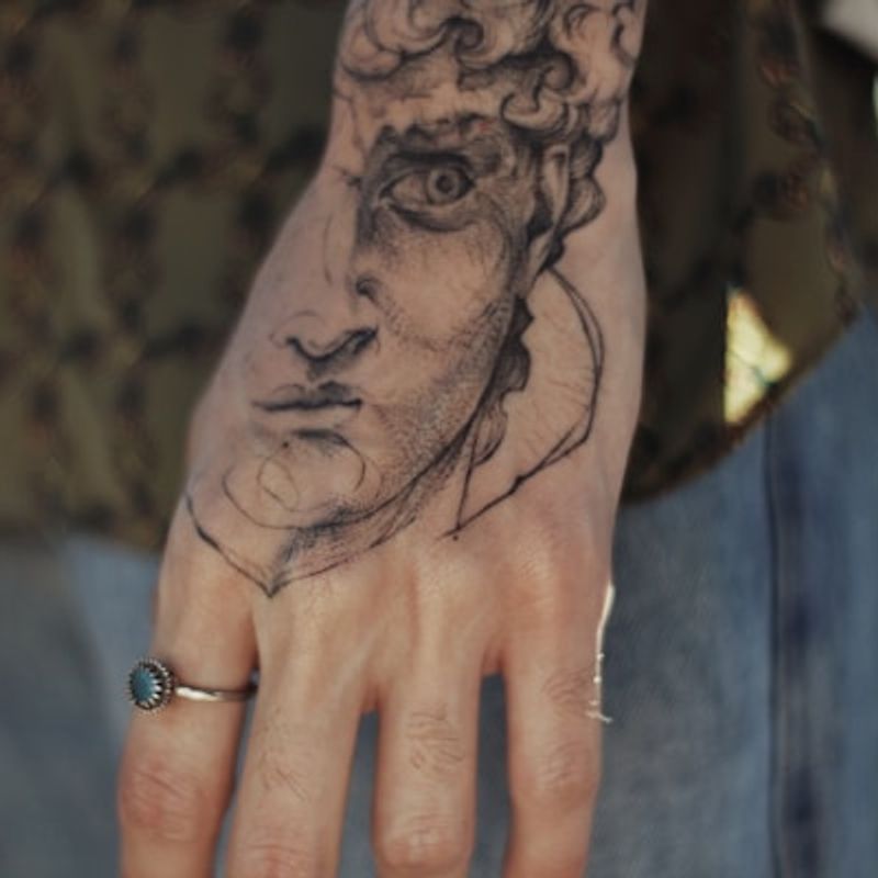 Realism black rose tattoo with detailed shading on forearm