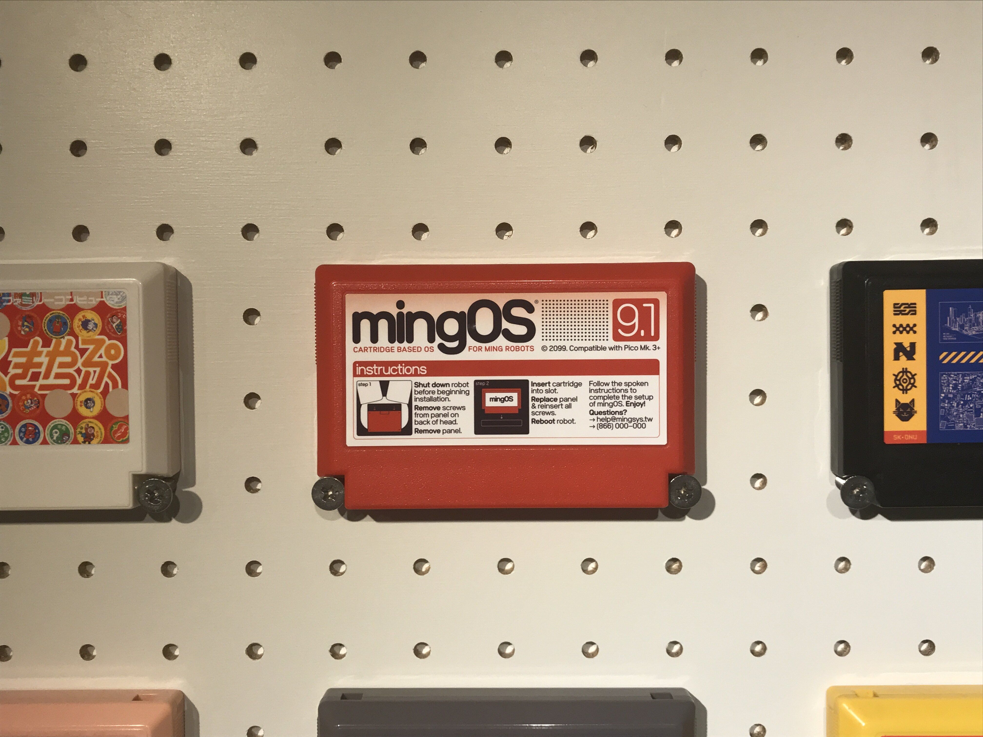 A red game cartridge titled “mingOS”, with an instructional diagram showing how to install the cartridge in a robot’s head.​​​​‌﻿‍﻿​‍​‍‌‍﻿﻿‌﻿​‍‌‍‍‌‌‍‌﻿‌‍‍‌‌‍﻿‍​‍​‍​﻿‍‍​‍​‍‌﻿​﻿‌‍​‌‌‍﻿‍‌‍‍‌‌﻿‌​‌﻿‍‌​‍﻿‍‌‍‍‌‌‍﻿﻿​‍​‍​‍﻿​​‍​‍‌‍‍​‌﻿​‍‌‍‌‌‌‍‌‍​‍​‍​﻿‍‍​‍​‍‌‍‍​‌﻿‌​‌﻿‌​‌﻿​​​﻿‍‍​‍﻿﻿​‍﻿﻿‌‍﻿​‌‍﻿﻿‌‍​﻿‌‍​‌‌‍﻿​‌‍‍​‌‍﻿﻿‌﻿​﻿‌﻿‌​​﻿‍‍​﻿​﻿​﻿​﻿​﻿​﻿​﻿​﻿​‍﻿﻿‌‍‍‌‌‍﻿‍‌﻿‌​‌‍‌‌‌‍﻿‍‌﻿‌​​‍﻿﻿‌‍‌‌‌‍‌​‌‍‍‌‌﻿‌​​‍﻿﻿‌‍﻿‌‌‍﻿﻿‌‍‌​‌‍‌‌​﻿﻿‌‌﻿​​‌﻿​‍‌‍‌‌‌﻿​﻿‌‍‌‌‌‍﻿‍‌﻿‌​‌‍​‌‌﻿‌​‌‍‍‌‌‍﻿﻿‌‍﻿‍​﻿‍﻿‌‍‍‌‌‍‌​​﻿﻿‌‌‍​‌​﻿‌﻿‌‍​﻿​﻿​‍​﻿‌﻿​﻿​‌​﻿‌﻿​﻿​​​‍﻿‌​﻿‍​​﻿‍‌‌‍‌‌​﻿​‌​‍﻿‌​﻿‌​​﻿‌‌‌‍​﻿​﻿​‍​‍﻿‌​﻿‍‌‌‍‌‌​﻿​‌​﻿‌﻿​‍﻿‌​﻿‌​​﻿‌﻿‌‍‌​‌‍​‍​﻿‌‌​﻿​​​﻿‍​‌‍‌‍​﻿‌‍‌‍‌‌​﻿​‌​﻿‌‍​﻿‍﻿‌﻿‌​‌﻿‍‌‌﻿​​‌‍‌‌​﻿﻿‌‌﻿​​‌‍﻿﻿‌﻿​﻿‌﻿‌​​﻿‍﻿‌﻿​​‌‍​‌‌﻿‌​‌‍‍​​﻿﻿‌‌‍​‍‌‍﻿﻿‌‍‌​‌﻿‍‌​‍‌‌​﻿‌‌‌​​‍‌‌﻿﻿‌‍‍﻿‌‍‌‌‌﻿‍‌​‍‌‌​﻿​﻿‌​‌​​‍‌‌​﻿​﻿‌​‌​​‍‌‌​﻿​‍​﻿​‍​﻿‍‌‌‍​‌​﻿‌﻿​﻿‍‌​﻿​​​﻿‍‌​﻿​​​﻿‌​​﻿‌‌​﻿​‌‌‍‌​​﻿​﻿​‍‌‌​﻿​‍​﻿​‍​‍‌‌​﻿‌‌‌​‌​​‍﻿‍‌‍‍‌‌‍﻿‌‌‍​‌‌‍‌﻿‌‍‌‌‌﻿​﻿​‍‌‌​﻿‌‌‌​​‍‌‌﻿﻿‌‍‍﻿‌‍‌‌‌﻿‍‌​‍‌‌​﻿​﻿‌​‌​​‍‌‌​﻿​﻿‌​‌​​‍‌‌​﻿​‍​﻿​‍‌‍‌​‌‍‌‌​﻿‍​​﻿​‌​﻿‌﻿​﻿‌​​﻿‌‍‌‍​‍​﻿‌​​﻿​﻿​﻿‍​‌‍‌​​‍‌‌​﻿​‍​﻿​‍​‍‌‌​﻿‌‌‌​‌​​‍﻿‍‌‍​‌‌‍﻿​‌﻿‌​​﻿﻿﻿‌‍​‍‌‍​‌‌﻿​﻿‌‍‌‌‌‌‌‌‌﻿​‍‌‍﻿​​﻿﻿‌‌‍‍​‌﻿‌​‌﻿‌​‌﻿​​​‍‌‌​﻿​﻿‌​​‌​‍‌‌​﻿​‍‌​‌‍​‍‌‌​﻿​‍‌​‌‍‌‍﻿​‌‍﻿﻿‌‍​﻿‌‍​‌‌‍﻿​‌‍‍​‌‍﻿﻿‌﻿​﻿‌﻿‌​​‍‌‌​﻿​﻿‌​​‌​﻿​﻿​﻿​﻿​﻿​﻿​﻿​﻿​‍‌‍‌‍‍‌‌‍‌​​﻿﻿‌‌‍​‌​﻿‌﻿‌‍​﻿​﻿​‍​﻿‌﻿​﻿​‌​﻿‌﻿​﻿​​​‍﻿‌​﻿‍​​﻿‍‌‌‍‌‌​﻿​‌​‍﻿‌​﻿‌​​﻿‌‌‌‍​﻿​﻿​‍​‍﻿‌​﻿‍‌‌‍‌‌​﻿​‌​﻿‌﻿​‍﻿‌​﻿‌​​﻿‌﻿‌‍‌​‌‍​‍​﻿‌‌​﻿​​​﻿‍​‌‍‌‍​﻿‌‍‌‍‌‌​﻿​‌​﻿‌‍​‍‌‍‌﻿‌​‌﻿‍‌‌﻿​​‌‍‌‌​﻿﻿‌‌﻿​​‌‍﻿﻿‌﻿​﻿‌﻿‌​​‍‌‍‌﻿​​‌‍​‌‌﻿‌​‌‍‍​​﻿﻿‌‌‍​‍‌‍﻿﻿‌‍‌​‌﻿‍‌​‍‌‌​﻿‌‌‌​​‍‌‌﻿﻿‌‍‍﻿‌‍‌‌‌﻿‍‌​‍‌‌​﻿​﻿‌​‌​​‍‌‌​﻿​﻿‌​‌​​‍‌‌​﻿​‍​﻿​‍​﻿‍‌‌‍​‌​﻿‌﻿​﻿‍‌​﻿​​​﻿‍‌​﻿​​​﻿‌​​﻿‌‌​﻿​‌‌‍‌​​﻿​﻿​‍‌‌​﻿​‍​﻿​‍​‍‌‌​﻿‌‌‌​‌​​‍﻿‍‌‍‍‌‌‍﻿‌‌‍​‌‌‍‌﻿‌‍‌‌‌﻿​﻿​‍‌‌​﻿‌‌‌​​‍‌‌﻿﻿‌‍‍﻿‌‍‌‌‌﻿‍‌​‍‌‌​﻿​﻿‌​‌​​‍‌‌​﻿​﻿‌​‌​​‍‌‌​﻿​‍​﻿​‍‌‍‌​‌‍‌‌​﻿‍​​﻿​‌​﻿‌﻿​﻿‌​​﻿‌‍‌‍​‍​﻿‌​​﻿​﻿​﻿‍​‌‍‌​​‍‌‌​﻿​‍​﻿​‍​‍‌‌​﻿‌‌‌​‌​​‍﻿‍‌‍​‌‌‍﻿​‌﻿‌​​‍​‍‌﻿﻿‌