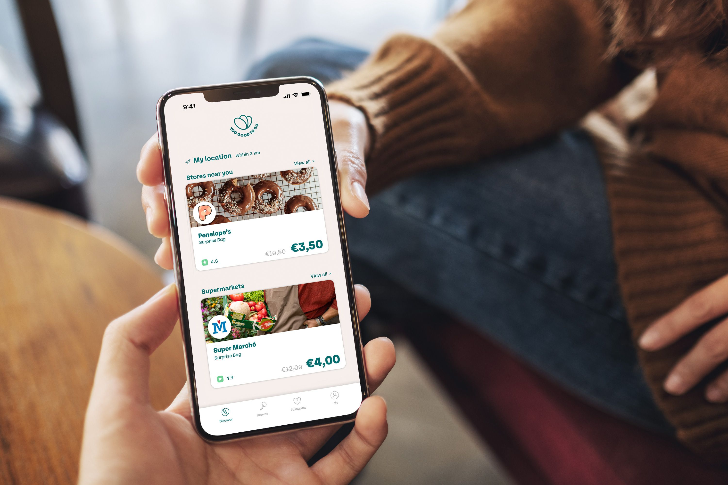 a person is holding a cell phone in their hand .