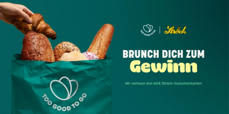 a person is holding a croissant in a bag that says too good to go