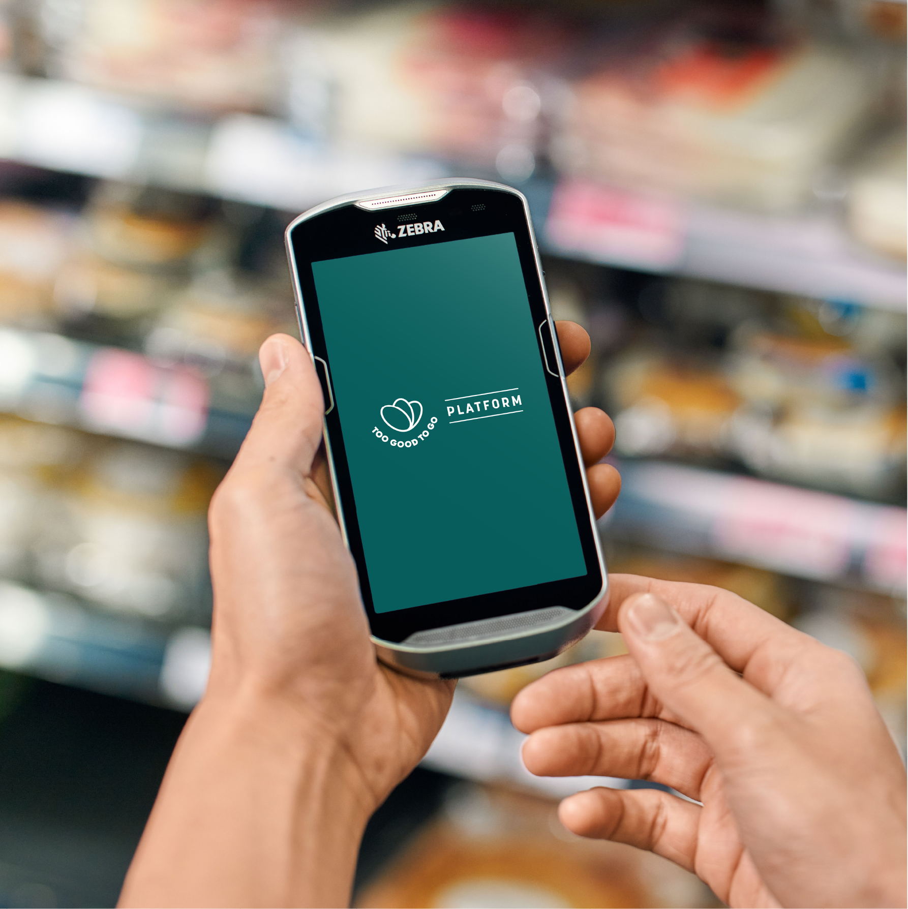 a person is holding a cell phone in a grocery store .