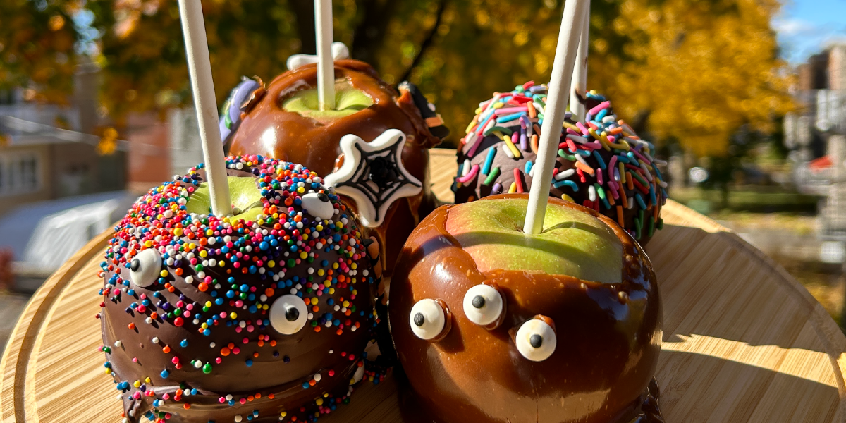 four caramel apples with eyes and sprinkles on them