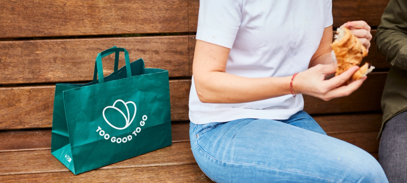Too Good To Go bag with vegetables on a table