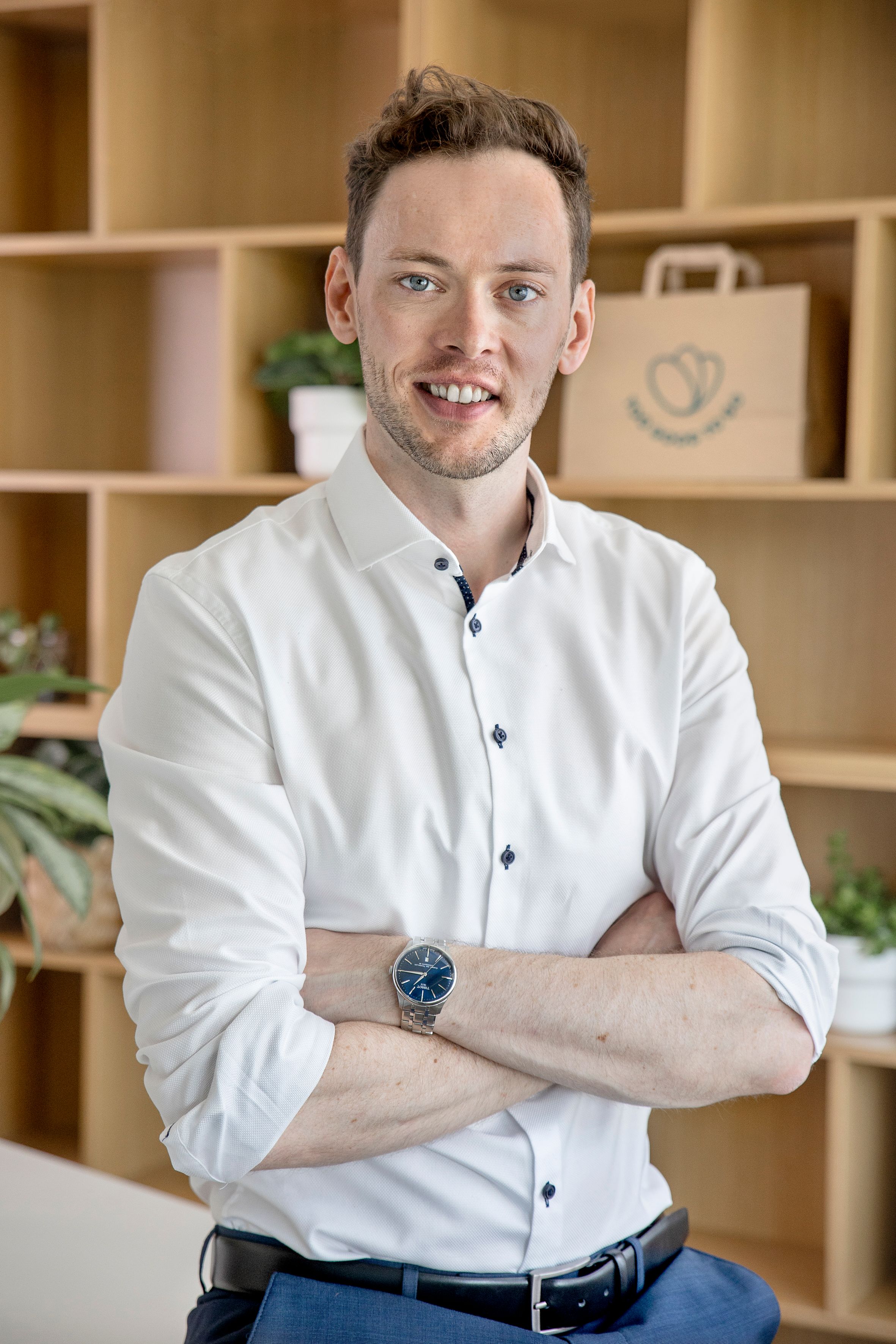 a man in a white shirt with his arms crossed