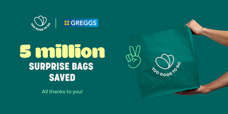 a person holding a green bag that says 5 million surprise bags saved