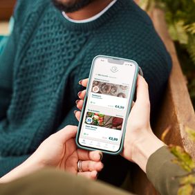 a person is holding a cell phone in their hand .