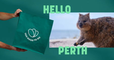 a person is holding a green bag that says too good to go