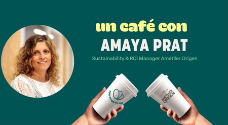 a woman is holding two coffee cups in her hands .