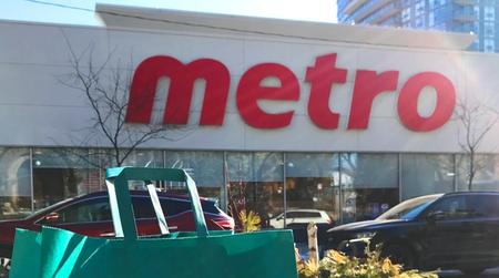 a green too good to go bag sits on a table in front of a metro store