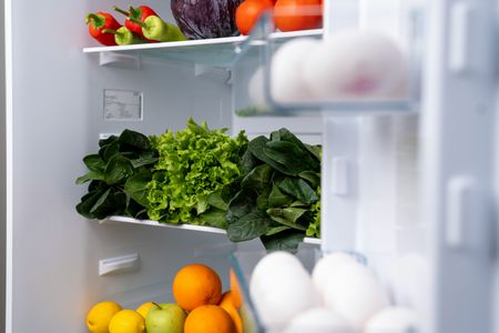 the inside of a refrigerator filled with fruits and vegetables .