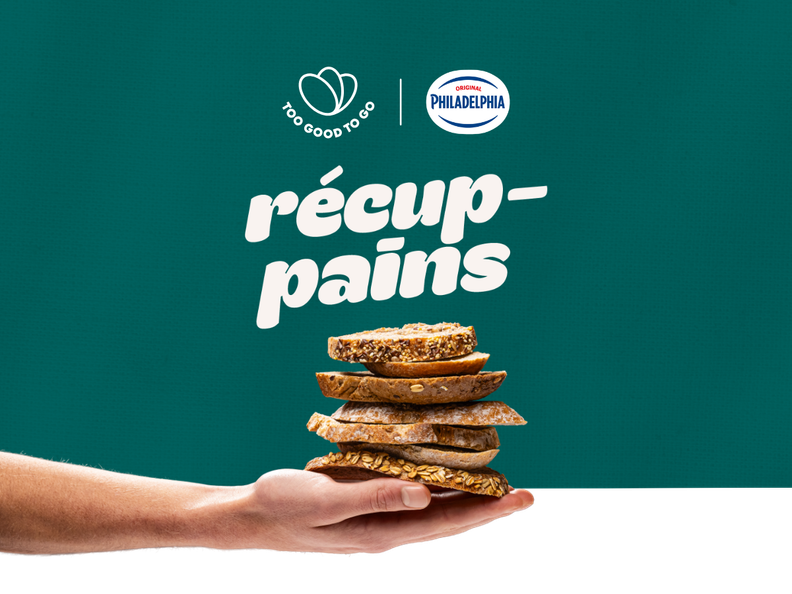 a hand holding a stack of slices of bread with a philadelphia logo in the background