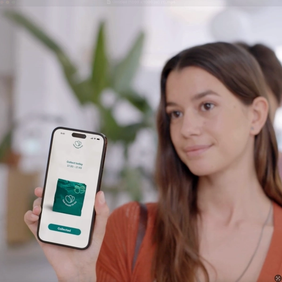 a woman is holding a cell phone with a green screen