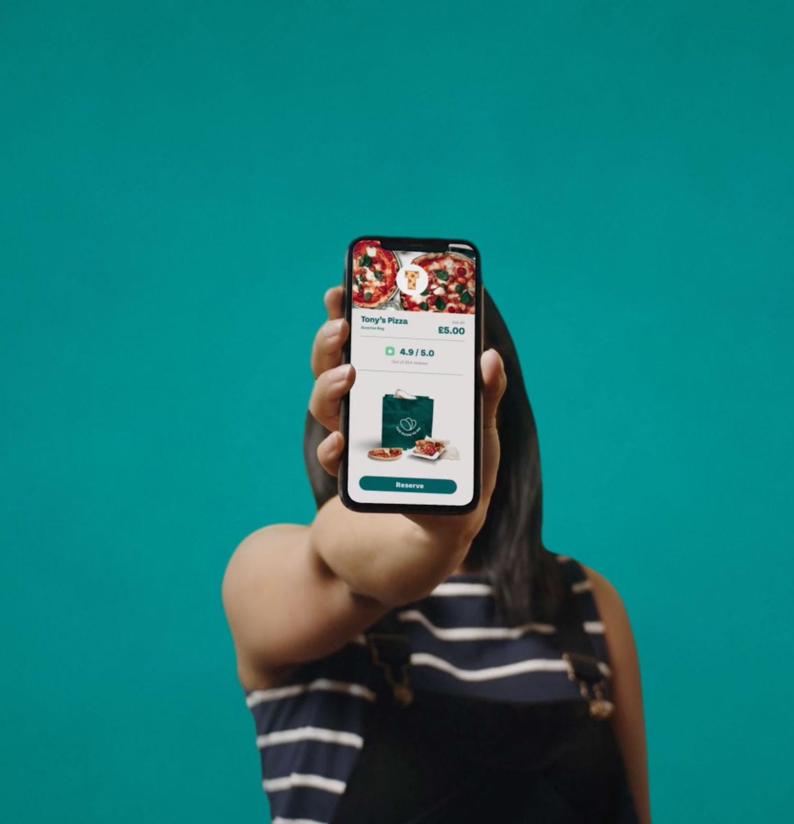 A women showing the Too Good To Go App Interface