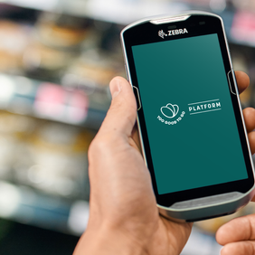 a person is holding a cell phone in a grocery store .