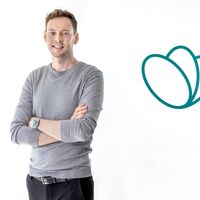 a man is standing with his arms crossed in front of a heart icon .
